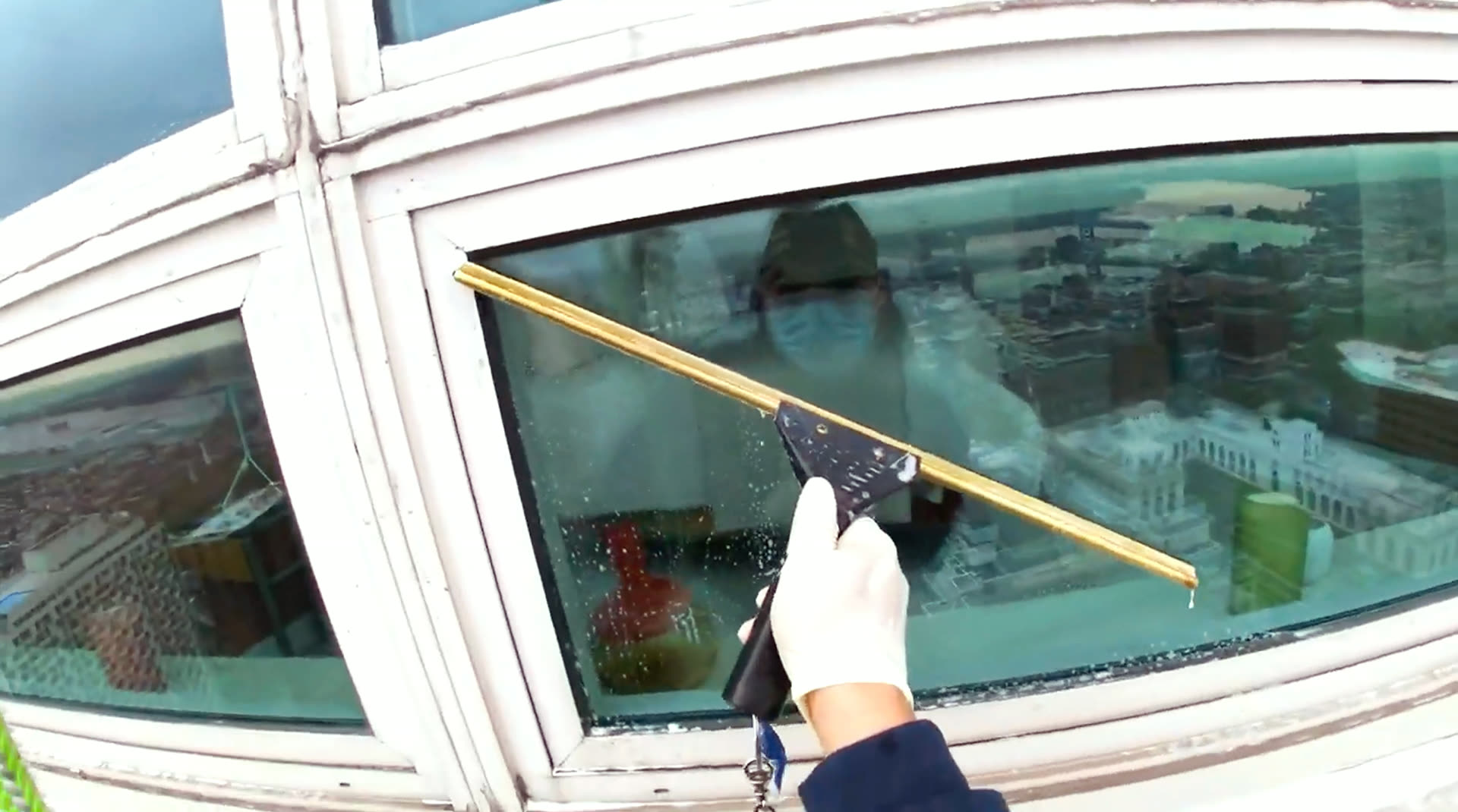 Premier Window Cleaning technician cleaning exterior glass on a commercial building